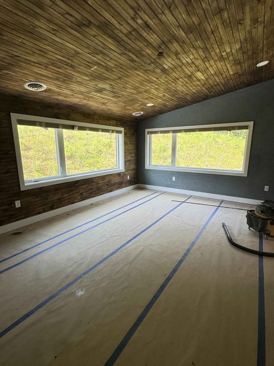 Interior room with protected flooring and taped edges during preparation